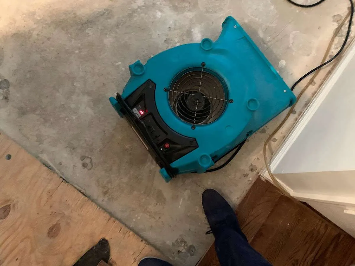Air mover drying subfloor during Commercial Water Damage Restoration in Menasha